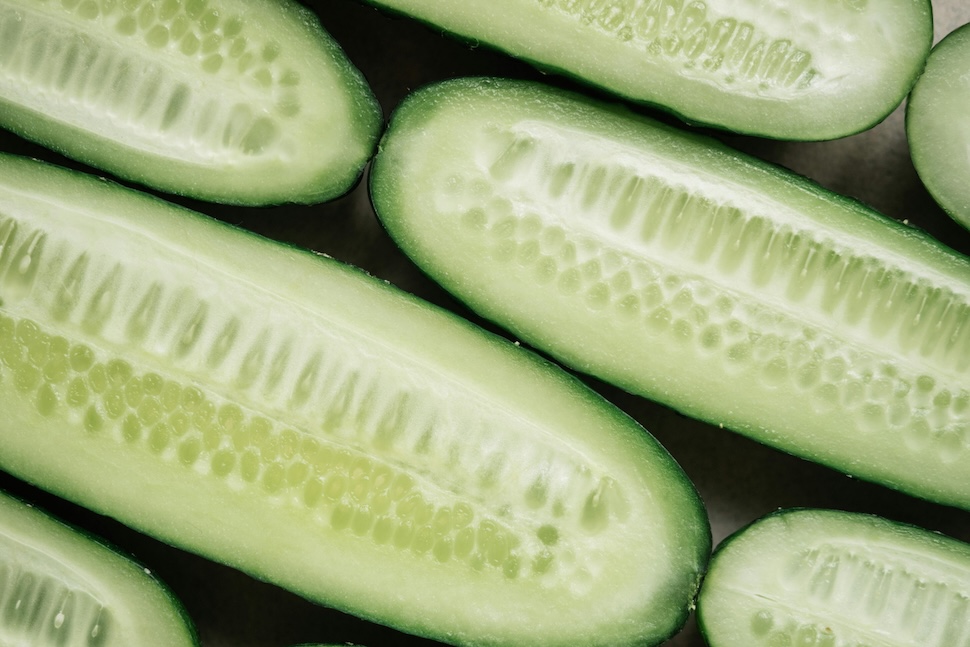 Slices of fresh cucumber, illustrating a top hydrating food you can eat.